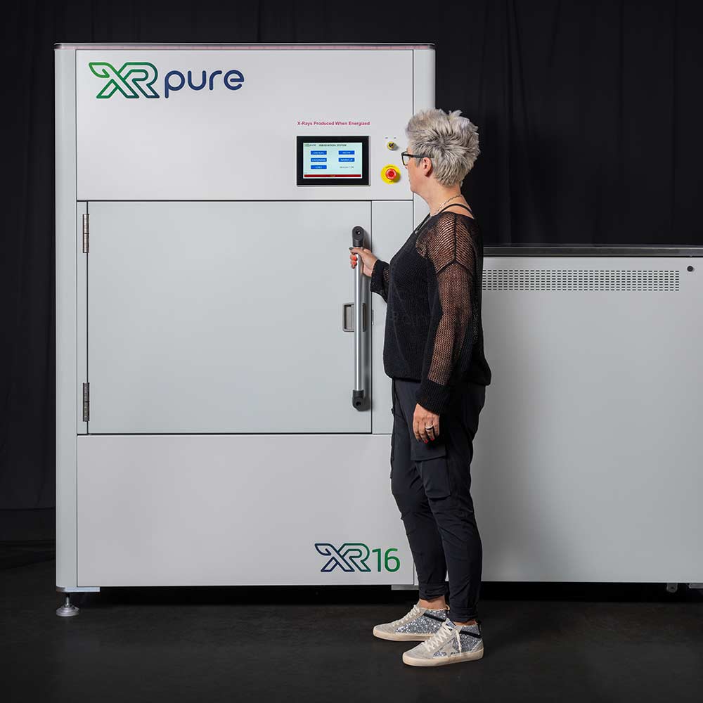 Worker holding door of the XRpure XR16: X-ray Cannabis Decontamination Machine